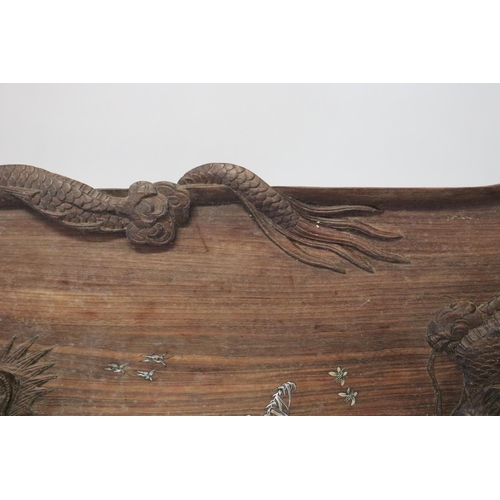 386 - Oriental hardwood twin handled tray decorated with dragon in relief and mother of pearl inlaid cente... 