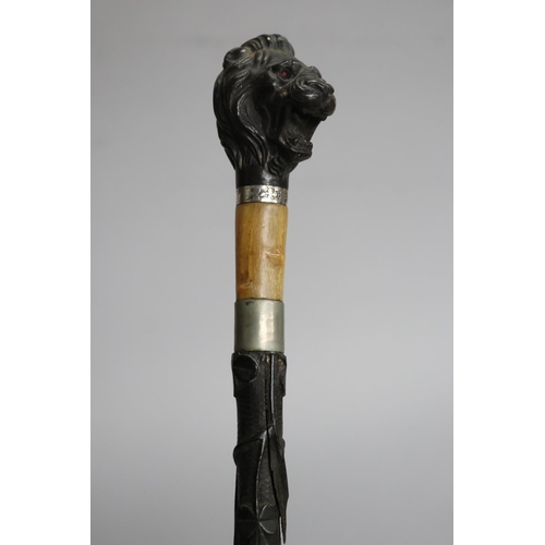 19 - Walking stick with lion head handle, has split to shaft, approx 81cm L