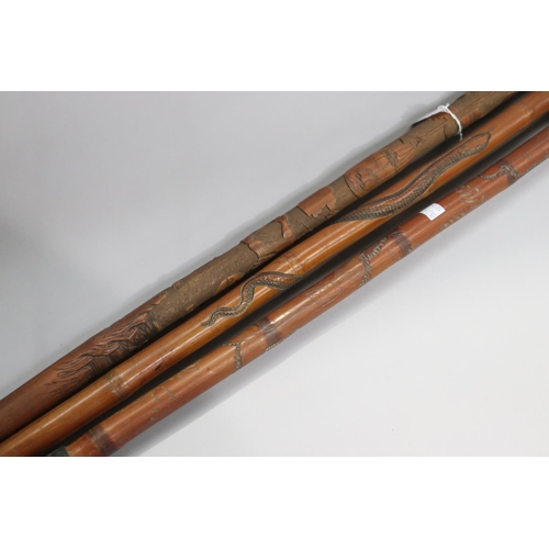24 - Lot of three South East Asian walking sticks, approx 88cm L & shorter (3)