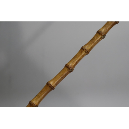 32 - Silver and bamboo stick, approx 65cm L
