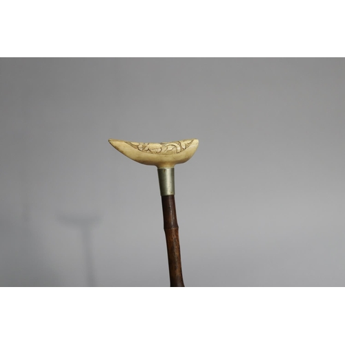 4 - Walking stick with a carved bone handle of floral motif, approx 88cm L