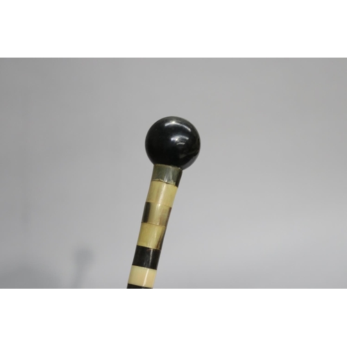 6 - Cut sectional design walking stick with a ball handle, approx 85cm L