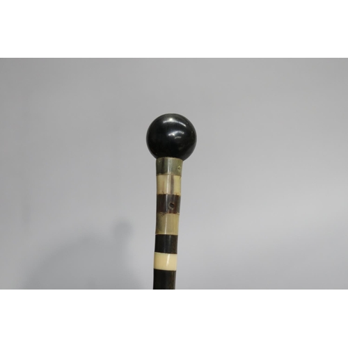 6 - Cut sectional design walking stick with a ball handle, approx 85cm L