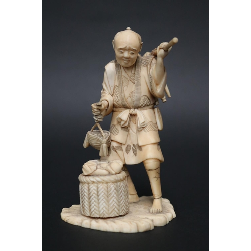 Well carved Japanese ivory figure of a farmer, holding tools & basket