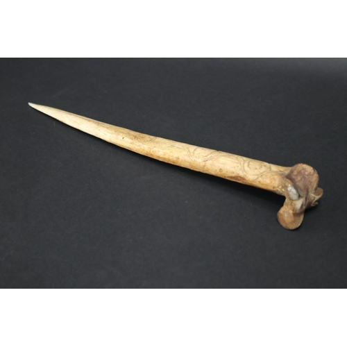 70 - Large old New Guinea carved bone dagger, Primative incised decoration, approx 41cm L