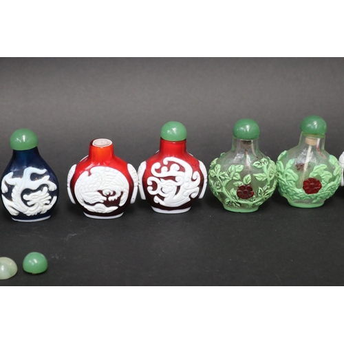 73 - Eleven Chinese Peking over lay glass snuff bottles, approx 7cm H and shorter (11)