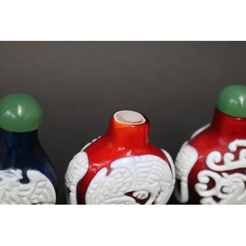 73 - Eleven Chinese Peking over lay glass snuff bottles, approx 7cm H and shorter (11)