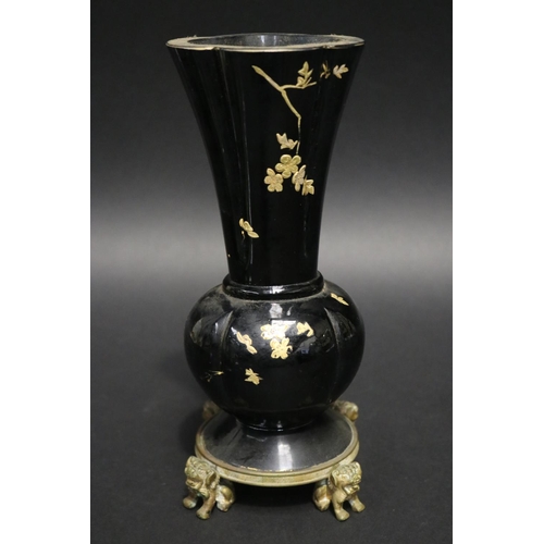 106 - Antique black glass vase with gilt highlight decoration, standing to a dog of fo motif base, approx ... 