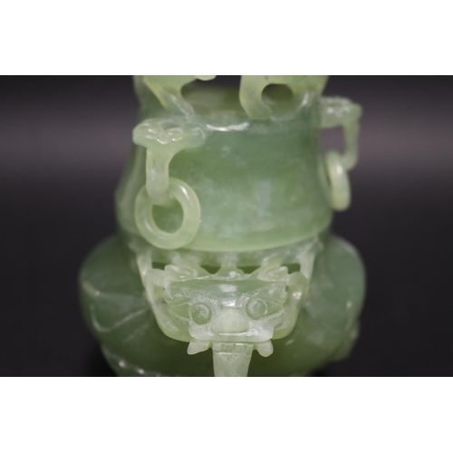 133 - Early 20th century Asian carved pale green jade lidded censer, mask head drop rings, approx 17cm H x... 