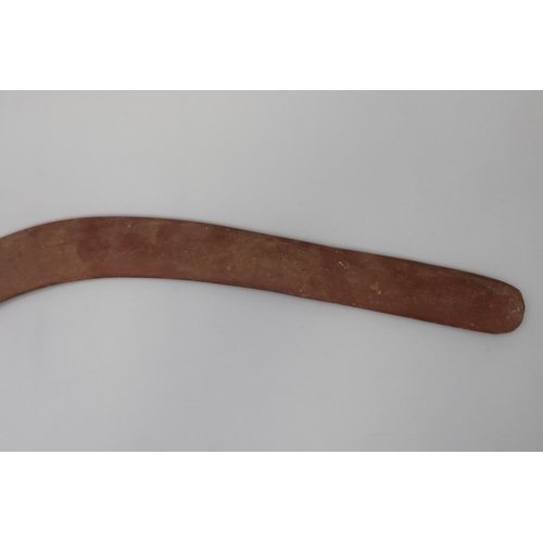 3040 - Bobby Tilmouth (1942-.) Australia (Aboriginal) Painted hardwood boomerang, 54.5 cm long