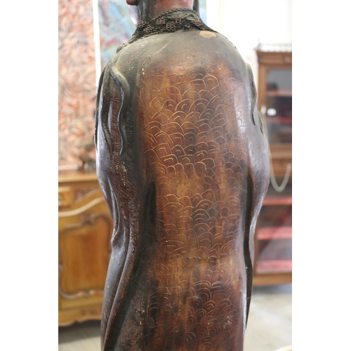 310 - Large red lacquered wood figure of Guanyin, some losses and flaking, approx 93cm H