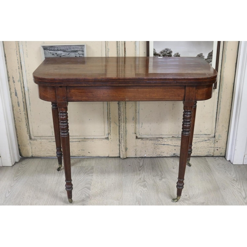 391 - Antique English Recency mahogany fold over card table, standing on multi ring turned tapering legs, ... 