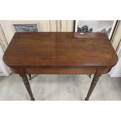 391 - Antique English Recency mahogany fold over card table, standing on multi ring turned tapering legs, ... 