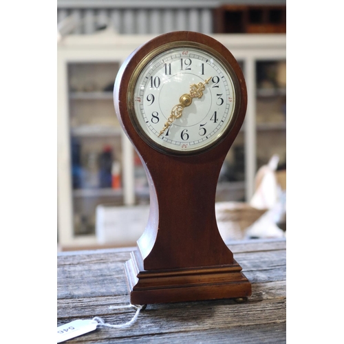 94 - Antique mahogany balloon clock, with key. Running at time of inspection, approx 24cm H