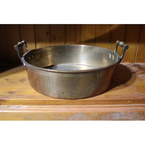 192 - Antique Early English brass twin handled pan, approx 9cm H excluding handles x 32cm Dia