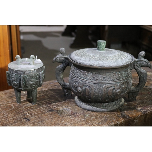 204 - Two Chinese ancient  bronze design lidded ice buckets, approx 22cm H x 35cm W and smaller (2)