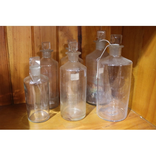 246 - Seven antique apocethary jars / bottles including a beaker and an extra stopper, approx 21cm H and s... 
