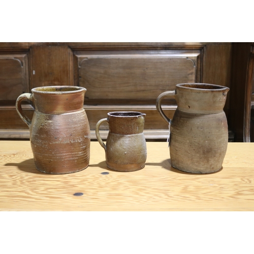 264 - Three antique French pottery jugs, approx 22cm H and shorter (3)