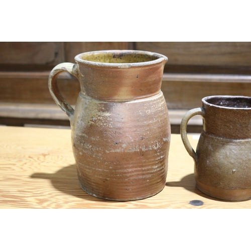 264 - Three antique French pottery jugs, approx 22cm H and shorter (3)