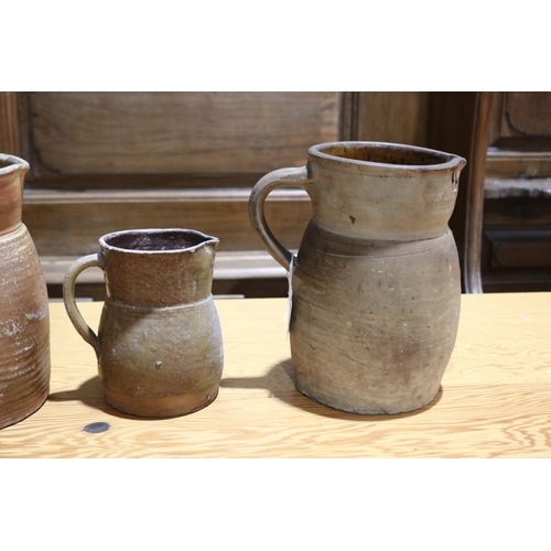 264 - Three antique French pottery jugs, approx 22cm H and shorter (3)