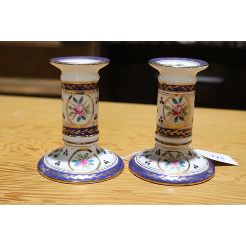 723 - Pair of squat form porcelain candlesticks, with gilt highlights (2)