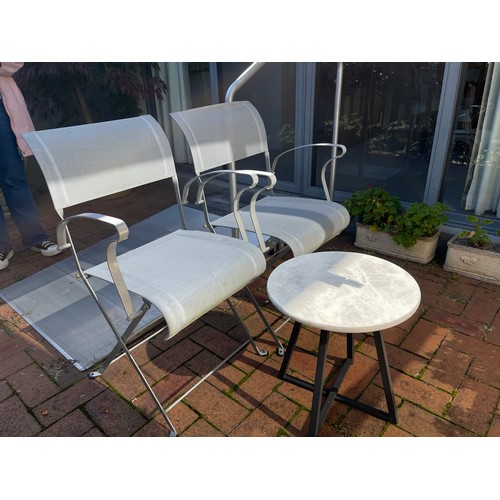 813 - Pair of folding mesh and iron patio chairs along with a modern marble topped table (3)