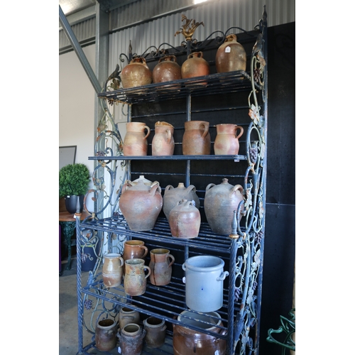 Impressive iron tiered bakers rack, with applied bunches of grapes and