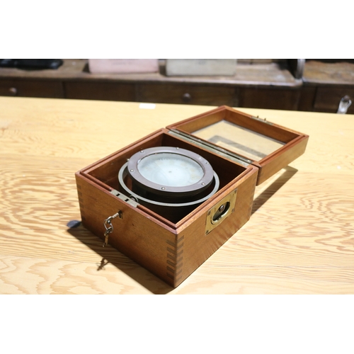 744 - Unmarked military grade boxed gimble compass. Brass hardware, with key. Box 20.cm x 20.5 cm Height 1... 