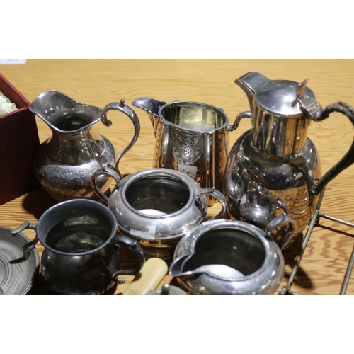 776 - Assortment of silver plate to include a bread knife, jugs, dishes etc