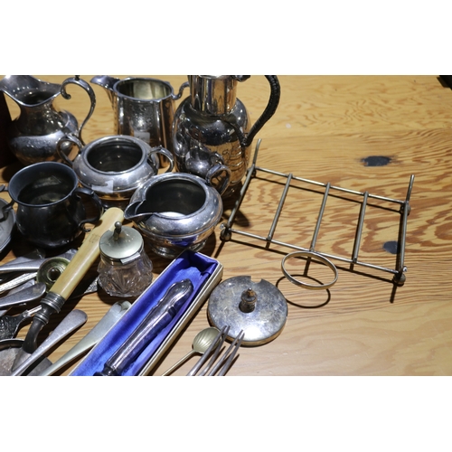 776 - Assortment of silver plate to include a bread knife, jugs, dishes etc