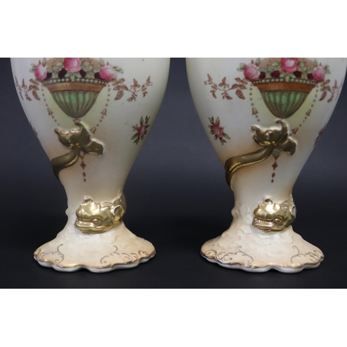 16 - Pair of Crown Devon blush ivory pedestal vases, decorated with swags of flowers above an hanging pla... 