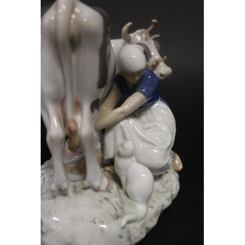 17 - Bing & Grondahl Copenhagen figure of a lady milking a cow, with cat in wait. Number 2017. Approx 18c... 