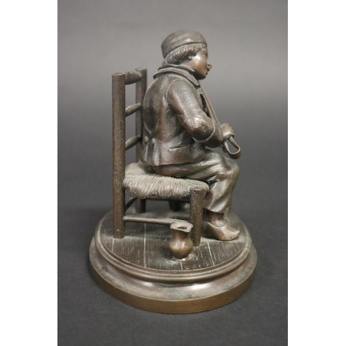 18 - Antique French or European bronze of a young boy playing bellows as a violin with coal nips, while s... 