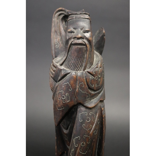 52 - Carved Oriental god figure with silver inlay work, on matched wooden base, approx 31cm H