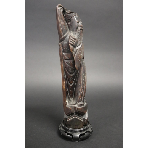 52 - Carved Oriental god figure with silver inlay work, on matched wooden base, approx 31cm H