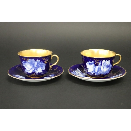 73 - Pair of antique Royal Worcester cups & saucers, in cobalt blue with gilt highlights, marked to base ... 