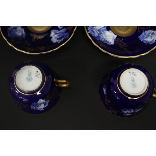 73 - Pair of antique Royal Worcester cups & saucers, in cobalt blue with gilt highlights, marked to base ... 