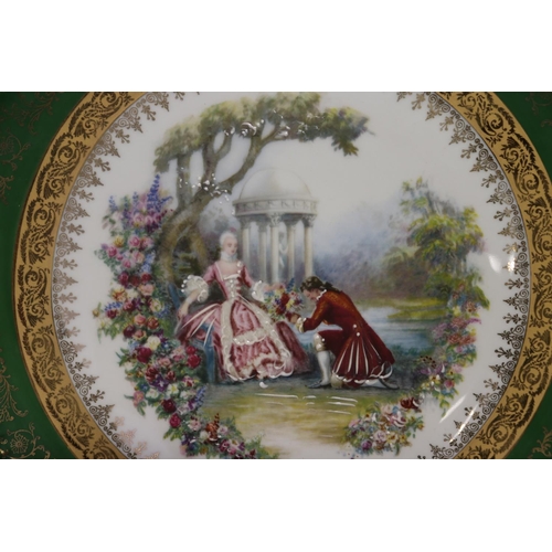 76 - French Limoges porcelain plate of green border with gilt highlights, showing a courting scene to cen... 