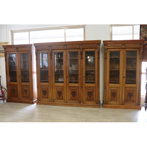 82 - Impressive antique carved oak set of three bookcases to include a four door example and a pair of tw... 
