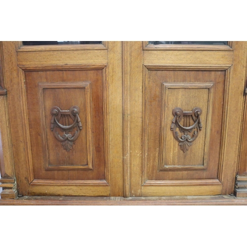 82 - Impressive antique carved oak set of three bookcases to include a four door example and a pair of tw... 