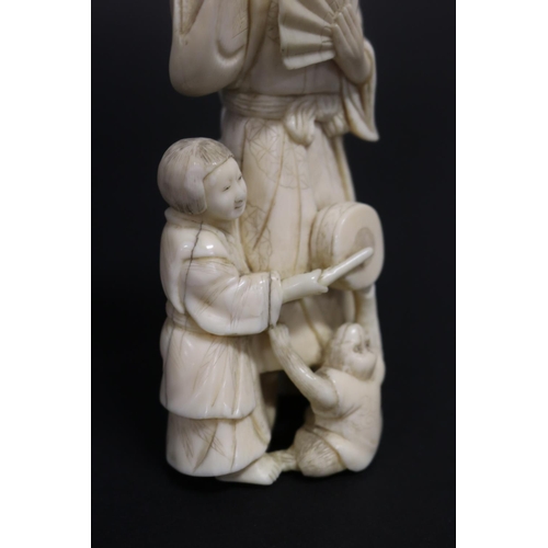 122 - Well carved Japanese okimono ivory figure group of man with fan, with little children beating drums,... 