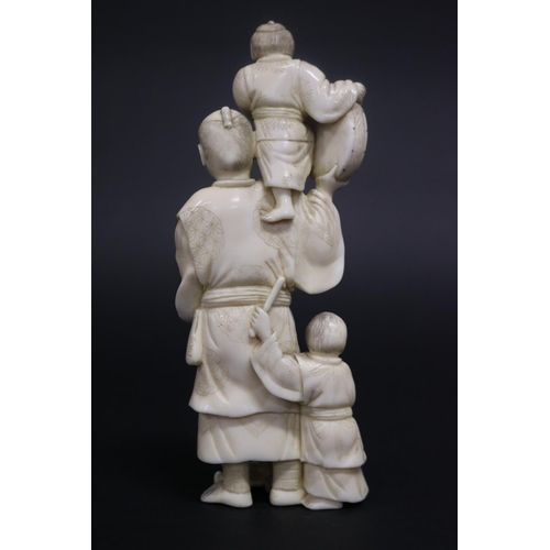 122 - Well carved Japanese okimono ivory figure group of man with fan, with little children beating drums,... 