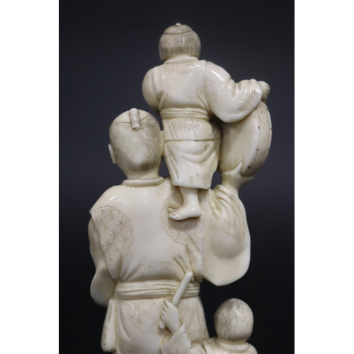 122 - Well carved Japanese okimono ivory figure group of man with fan, with little children beating drums,... 