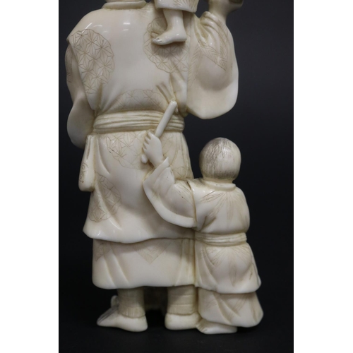 122 - Well carved Japanese okimono ivory figure group of man with fan, with little children beating drums,... 