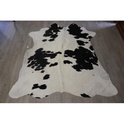 186 - Cow hide floor rug, approx 215cm x 203cm