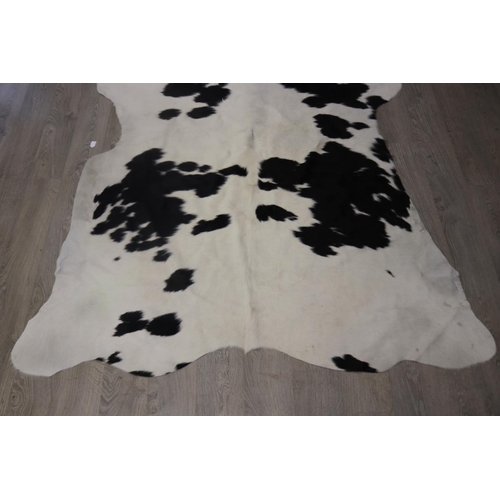 186 - Cow hide floor rug, approx 215cm x 203cm