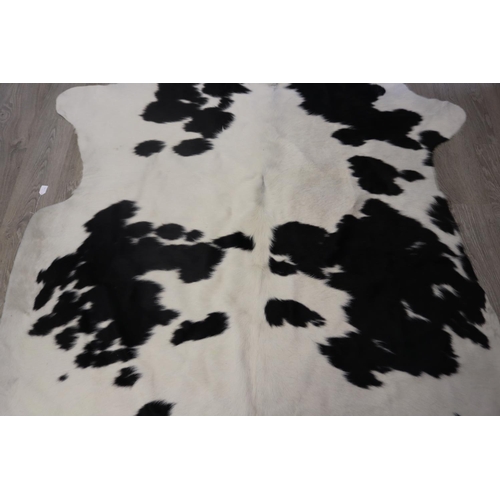 186 - Cow hide floor rug, approx 215cm x 203cm