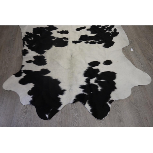 186 - Cow hide floor rug, approx 215cm x 203cm