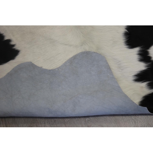 186 - Cow hide floor rug, approx 215cm x 203cm