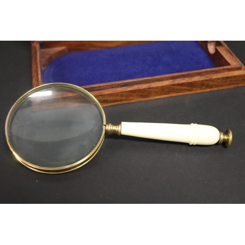 114 - Hand held magnifier glass in fitted wooden case, approx 24cm L